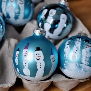  Homemade Handprint Snowman Ornaments gifts under $10 #HomemadeGiftIdeas #ChristmasTradition Gifts the kids can make that people will really like